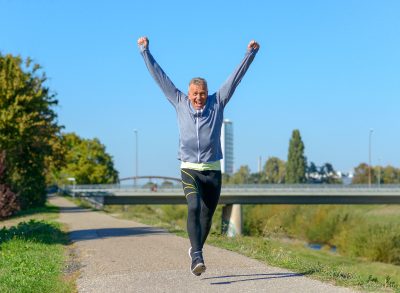 happy fit man walks after succeeding daily step goal