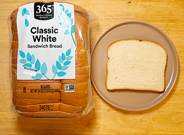 loaf of 365 white bread next to slice on a plate 