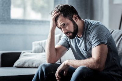 man stressed on couch