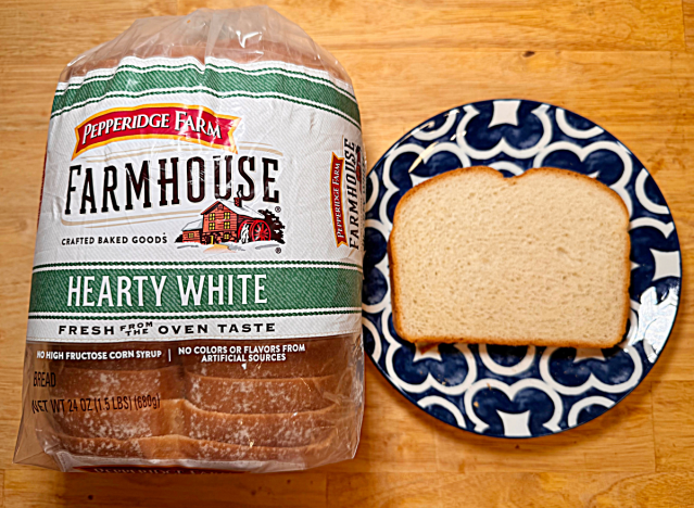 a loaf of pepperidge farm hearty white bread with a printed plate and a slice of bread on it 