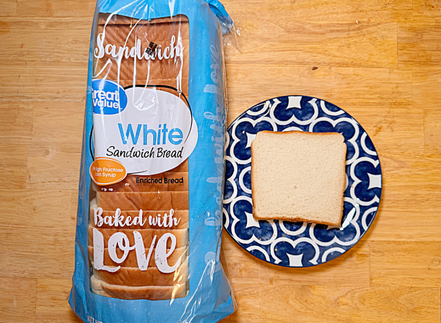 a loaf of great value white bread next to a printed plate with a slice of white bread 