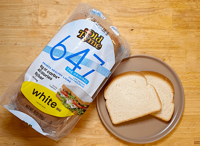 a loaf of schmidt old tyme white bread with two slices on a plate 