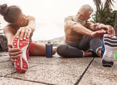 couple stretching before workout, demonstrating bad fitness habits