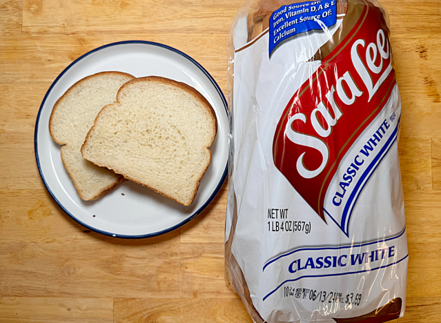 loaf of sara lee white bread with two slices on a plate 