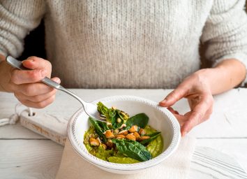 https://www.eatthis.com/wp-content/uploads/sites/4/2022/04/woman-eating-spinach-lunch-bowl.jpg?quality=82&strip=all&w=354&h=256&crop=1