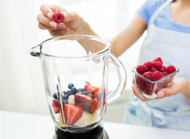 woman making smoothie