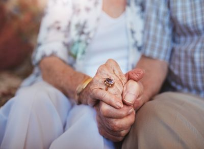 Old couple holding hands