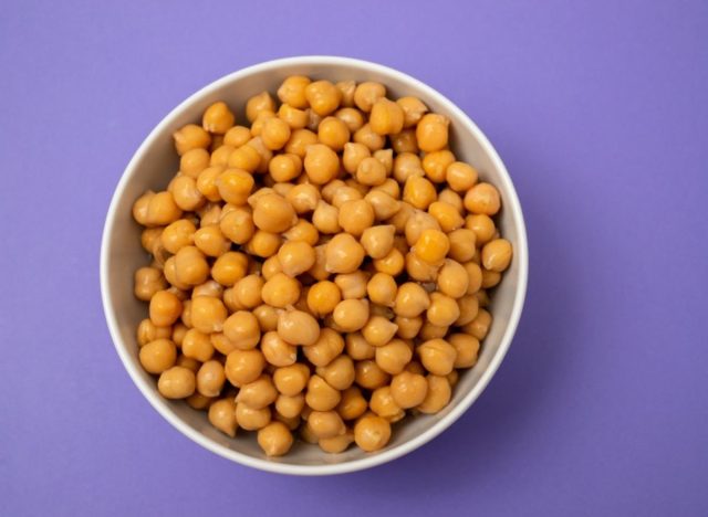 bowl of canned chickpeas on a purple background