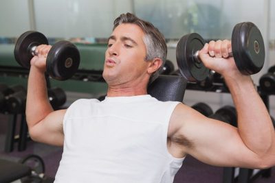 fit mature man doing dumbbells workout