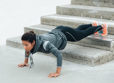 fit woman doing elevated pushup to break the plateau and lose weight