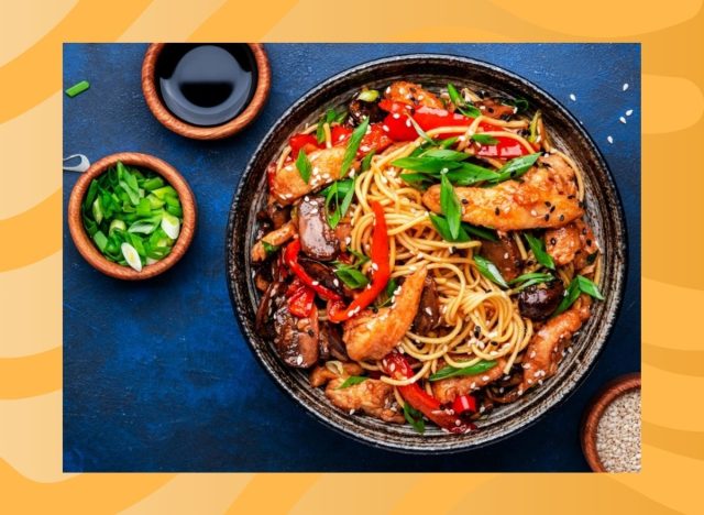 plate of stir-fry noodles on a yellow background