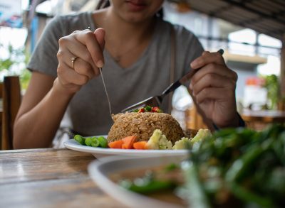 woman eating rice