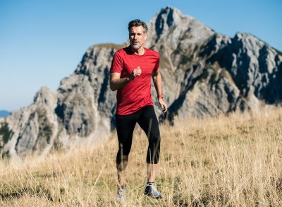 man running through field, cardio exercise that will add years to your life