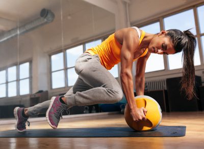 fit woman doing the most popular exercises in front of mirror