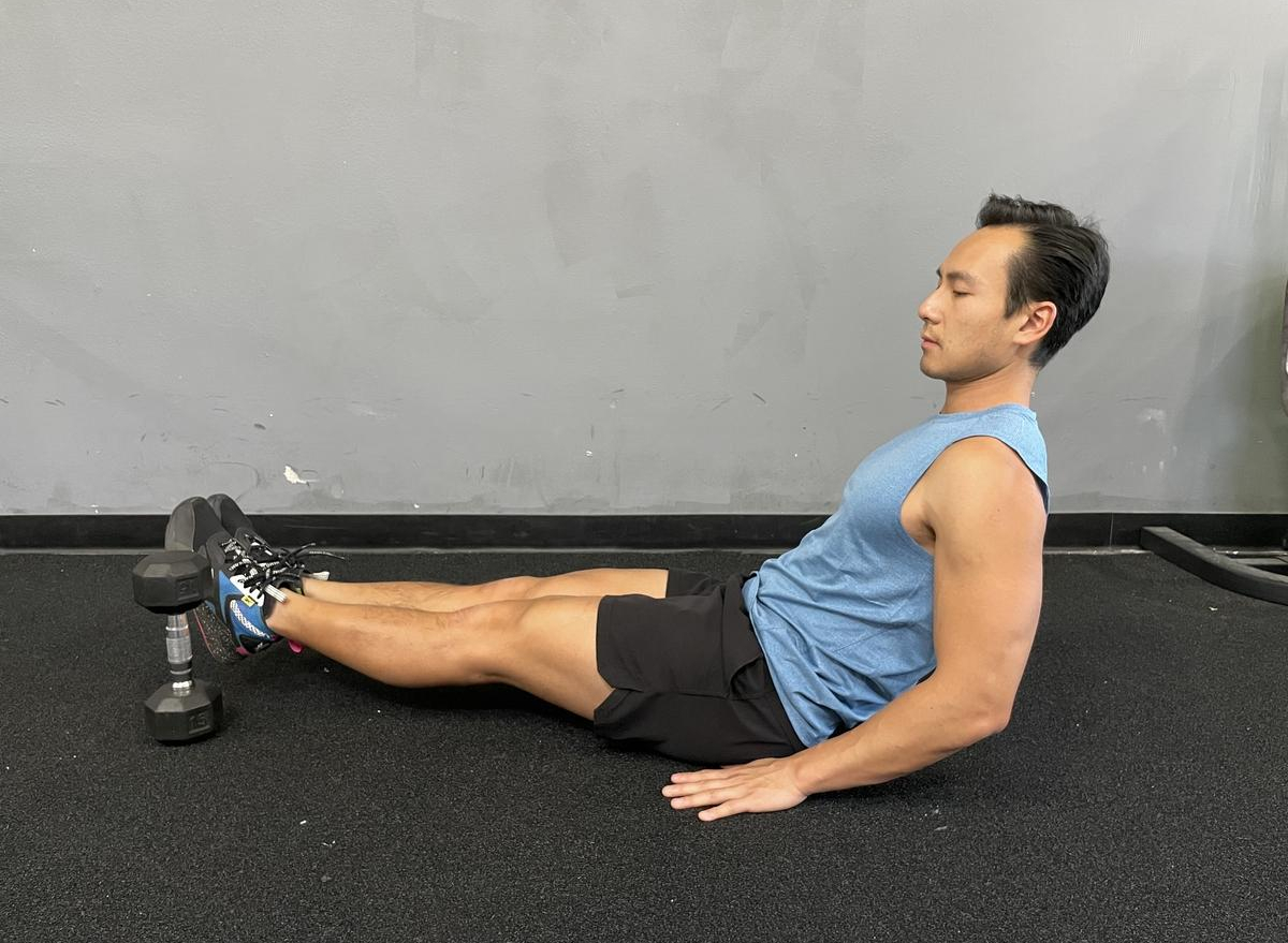 Leg lift over outlet dumbbell