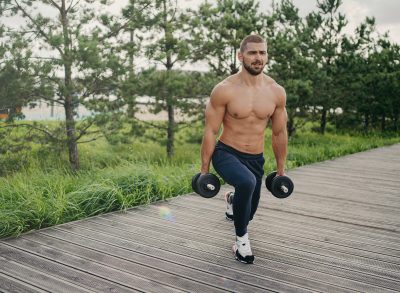 man demonstrating dumbbell exercises to get rid of a sagging belly