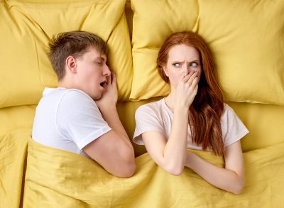 couple in bed, concept of how to get rid of morning breath fast