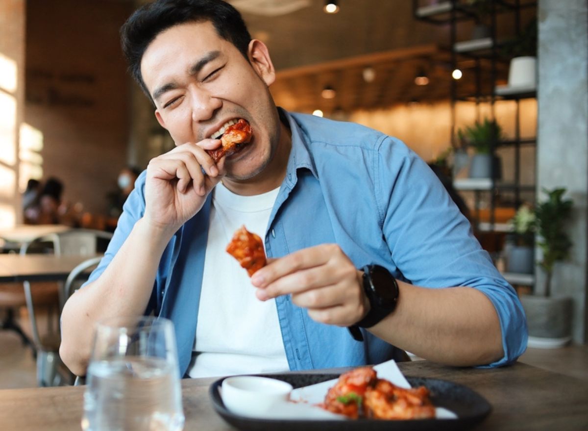 Man eating chicken wings