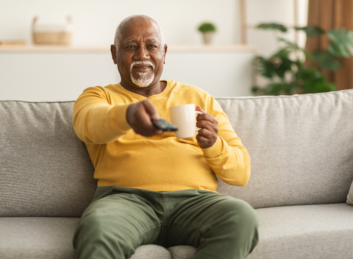 mature man sedentary at 60 on the couch watching tv