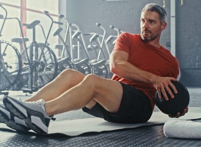 mature man medicine ball exercise demonstrating getting a fitter body after 50