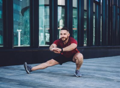 man doing side lunge workout to lose the extra 10 pounds