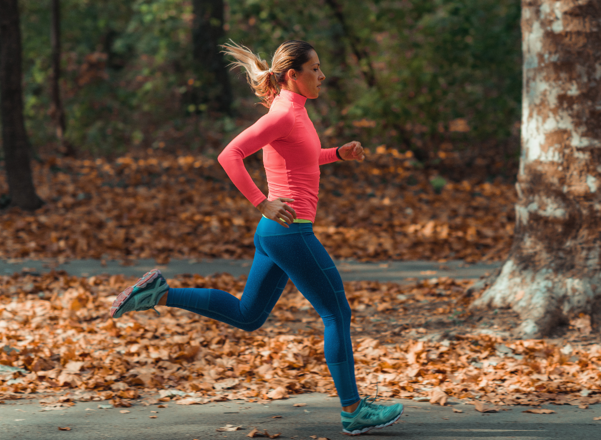 https://www.eatthis.com/wp-content/uploads/sites/4/2022/08/woman-running-autumn.jpg?quality=82&strip=1