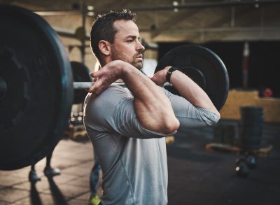 man performing dad bod workout with barbell