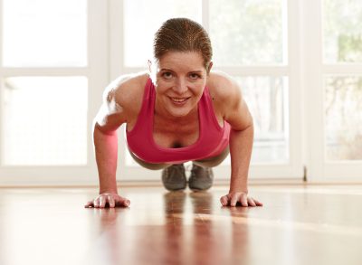 mature woman performing pushups, bodyweight exercises for bingo wings