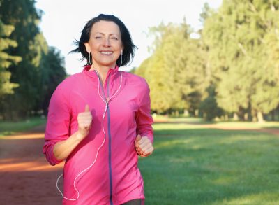 mature woman running cardio outdoors