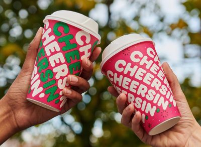 people holding dunkin' holiday cups