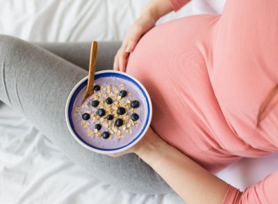 pregnant woman eats blueberry yogurt