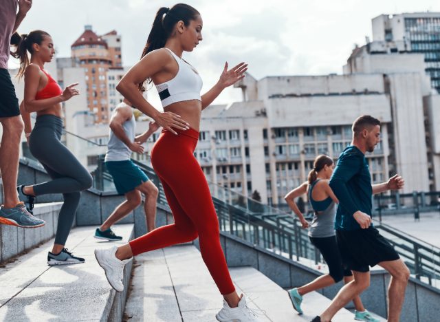 woman sprinting stairs bodyweight workout to lose 10 pounds in a month