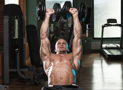 fitness man doing chest workouts with dumbbells for stronger, bigger pecs