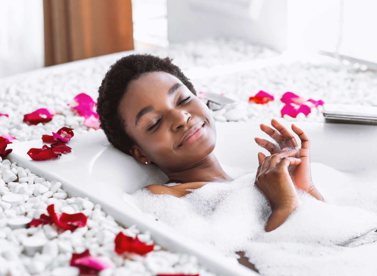 woman taking relaxing bubble bath winter self-care hacks