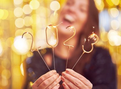 woman holding 2023 sparklers for New Year's, concept of New Year's 2023 Instagram captions