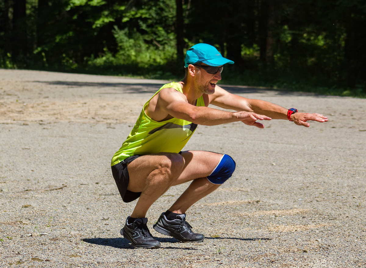 middle-aged man doing plyometrics explosive exercises outdoors