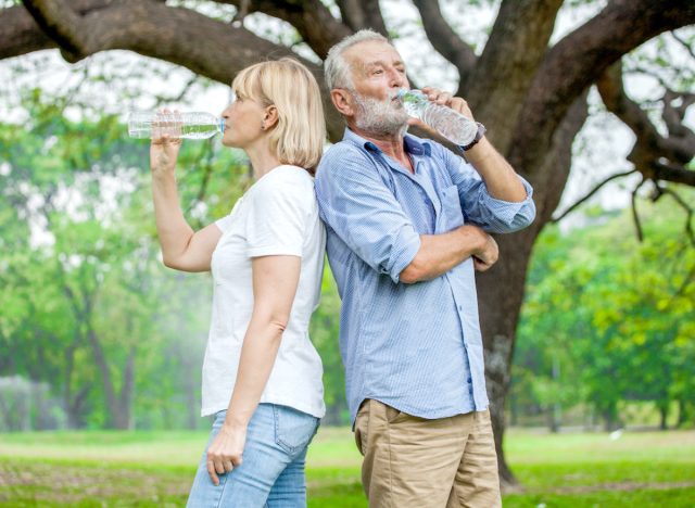 senior couple drinking water, demonstrating ways to stay healthy without exercising