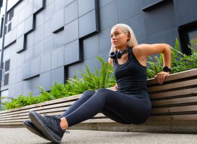 woman doing bodyweight tricep dips, concept of exercises to get rid of underarm fat