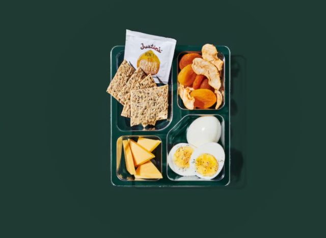 Eggs and gouda protein box from Starbucks on a green background