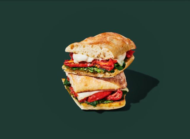 Starbucks tomato mozzarella sandwich on a green background