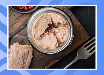 can of tuna on a wooden table on a blue background