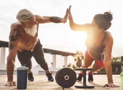 fitness couple doing strength bodyweight workout outdoors, concept of how to build muscle as you age