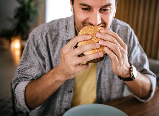 man eating a hamburger