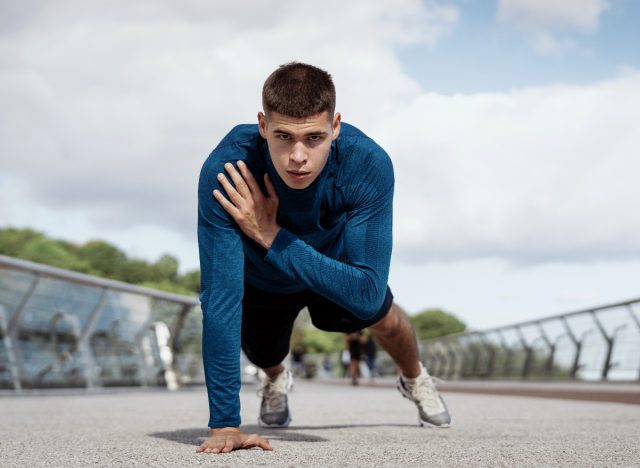 fit man demonstrating plank shoulder taps to reach your ideal weight fast