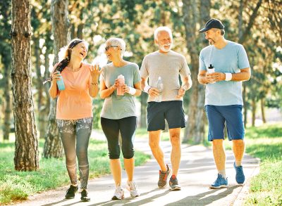 two happy senior couples walking and talking, concept of boosting your daily steps to extend your life