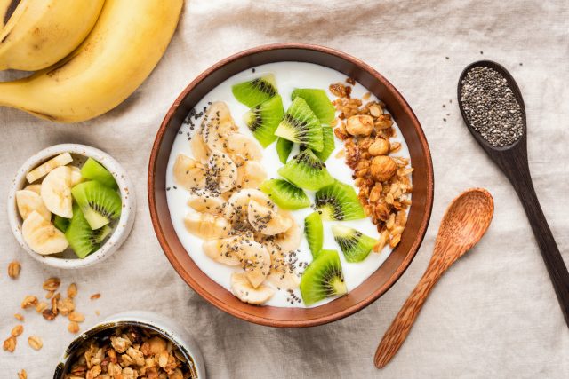 Breakfast Bowl With Yogurt Granola Fruits Kiwi Banana Chia Seeds, which help you poop.