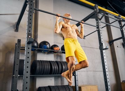 mature man doing pull-ups exercises to build total-body muscle