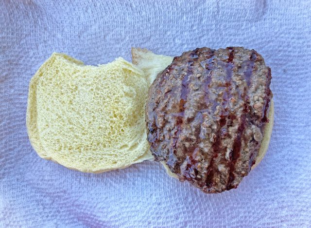 A previously frozen burger patty from Whole Foods Market, fresh off the grill and served on a bun