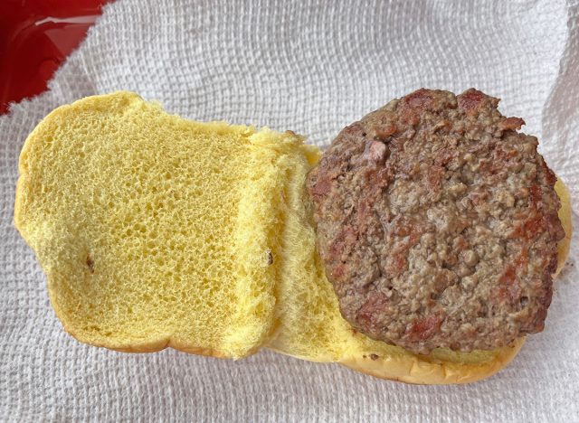A cooked burger patty from Trader Joe's served on a bun