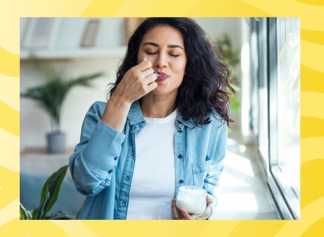 woman eating yogurt on a yellow background